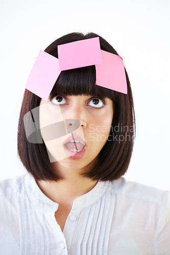 Image of Confused, planning and woman brainstorming in studio with a shock, surprise or thinking face expression. Idea, contemplating and female model with paper notes on her head isolated by white background