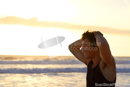 Image of Relax, happy and sunset with man at beach for vacation, seaside travel and summer break. Smile, happiness and peace with male tourist on coastline for calm, holiday and freedom with sky mockup