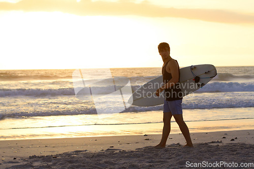 Image of Sunset, surfing man and walking at the beach with surfboard. Athlete, summer vacation or holiday and professional male surfer training or exercising water sports at the ocean or sea on mockup space