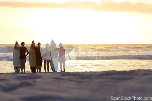 Image of Surfer group, silhouette and sunset with space for mockup at beach for freedom, youth and nature. People, women and men outdoor by ocean, sunshine or waves in summer, holiday and relax with surfboard