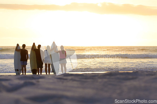 Image of Surfer group, silhouette and beach with space for mockup on vacation for freedom, youth or nature. People, women and men outdoor by ocean, sunset and waves in summer, holiday and relax with surfboard