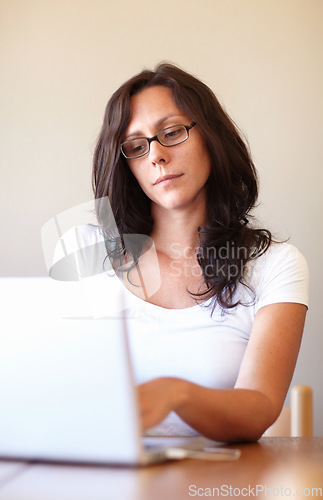 Image of Woman, reading and typing on laptop in home office for remote work, entrepreneurship or online business. Businesswoman, entrepreneur and computer for research, email communication or social network