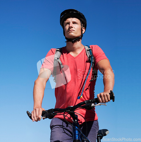 Image of Sky, bike and man focus on cycling journey, sports workout or travel adventure for fitness, exercise or outdoor cardio. Thinking, athlete training and male person riding bicycle for transportation