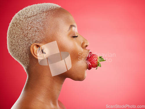 Image of Woman, strawberry and studio for beauty, profile and skincare for wellness, health and diet by red background. African model girl, healthy fruit and mouth with eyes closed, nutrition and cosmetics