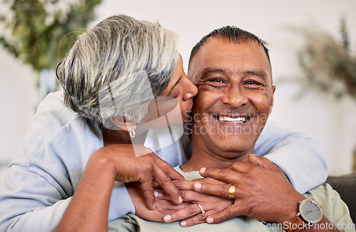 Image of Love portrait, kiss and happy elderly couple bond, relax and enjoy time together, smile and retirement wellness. Home apartment, sofa and face of elderly man, woman or people with marriage happiness