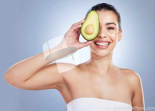 Image of Avocado, skincare and portrait of latino woman in studio happy with detox, wellness or omega 3 treatment on grey background. Fruit, face and lady model smile for anti aging or vitamin c facial beauty