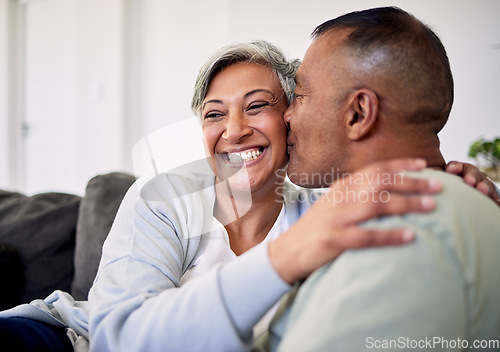 Image of Love kiss, face and elderly couple happiness, romantic bond and enjoy quality time together, smile and retirement wellness. Living room sofa, care and senior man, old woman or people happy at home