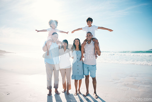 Image of Holiday, beach and portrait of happy family bonding together at the sea or ocean for love, care and happiness. Travel, sun and parents with children or kids and grandparents on a vacation for freedom