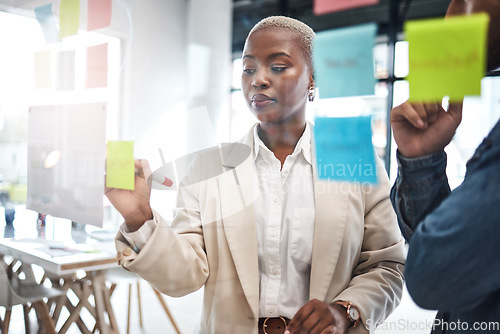 Image of Black woman, writing and schedule planning in meeting for brainstorming, teamwork or tasks at office. African female person or employee working on team strategy, ideas or business agenda at workplace