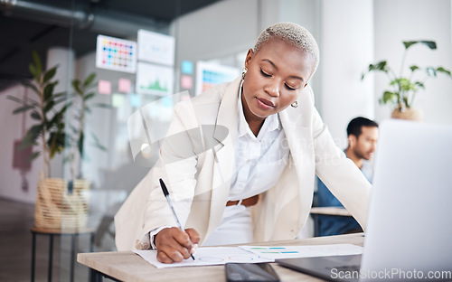 Image of Business woman, writing focus and graphic designer with notes and information for project. Company, African female person and design in office with pen and document for website work at agency