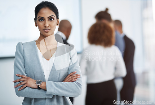 Image of I will achieve all of my goals. Portrait of a young businesswoman in the office with her colleagues in the background.