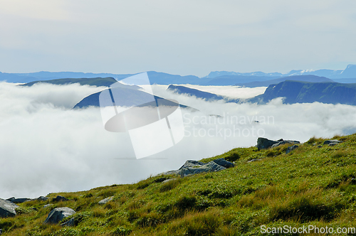 Image of Mountain peaks poked out of the fog at the coast