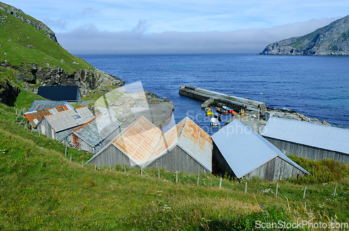 Image of Boathouse and harbor by the coast