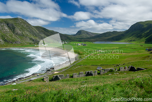 Image of Green fields and white waves towards the beach