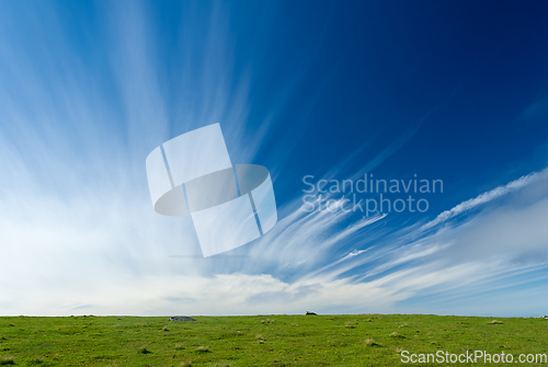 Image of Blue sky with clouds stretching towards the sky