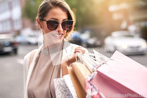 Image of Fashion, shopping bag or rich girl in city or urban street for boutique retail sale or clothes discount deals. Sunglasses, financial freedom or trendy customer walking on road with luxury products