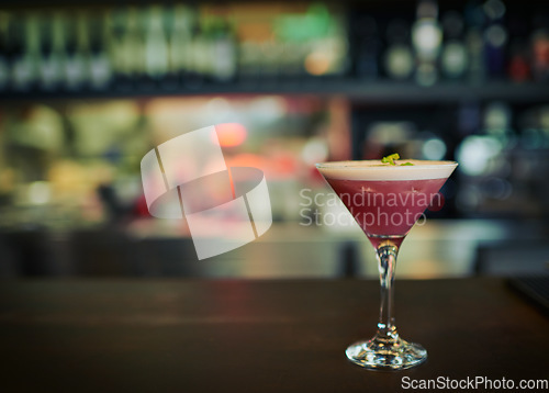 Image of Fruit cocktail, glass and alcohol drink on counter at pub, night club and bar for restaurant service. Nightclub mockup, party and closeup of pink beverage on wooden table for person with copy space