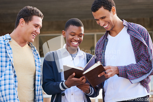 Image of Comparing notes. Cropped shot of a group of university students looking through their notes together on campus.