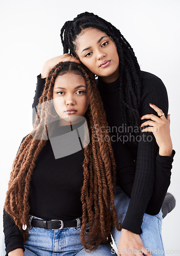 Image of Together they inspire beauty. Studio shot of two beautiful young women posing against a grey background.