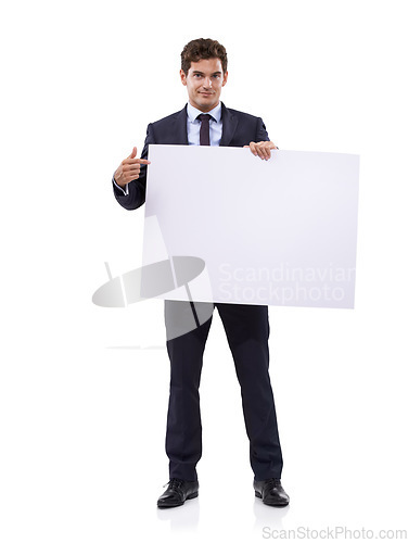 Image of Getting your attention with a large sign. A handsome young businessman holding a large placard.