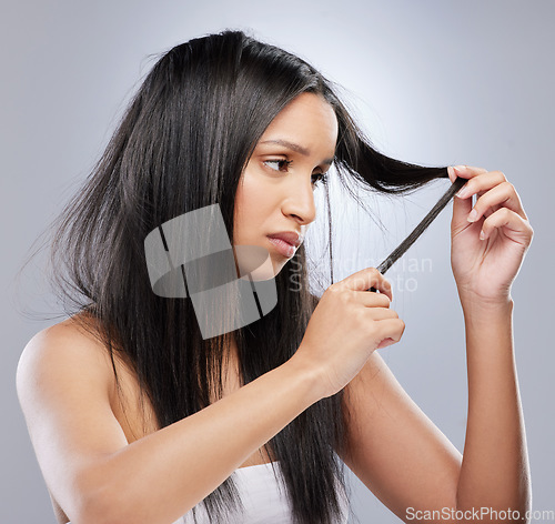 Image of Hair crisis, damage and woman in studio with worry for split ends, haircare crisis and weak tips. Beauty, hairdresser and face of worried female person with frizz strand problem on gray background