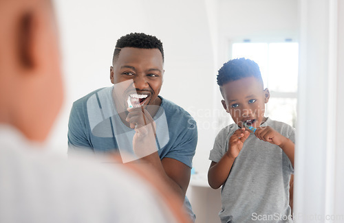 Image of Black man brushing his teeth with his kid for dental hygiene, health and wellness in the bathroom. Oral care, teaching and young African father doing morning mouth routine with his boy child at home.