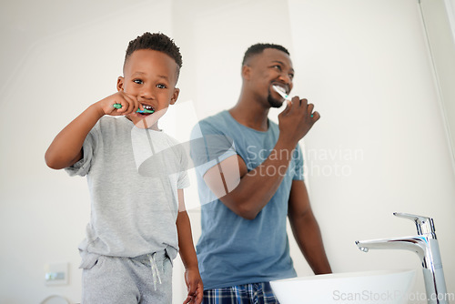 Image of African father, bathroom and son with toothbrush, care or love for cleaning, hygiene or dental wellness. Black man, boy and brushing teeth in family house with health, smile or clean mouth in morning
