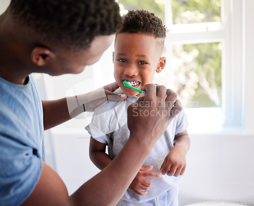 Image of African father, teaching son and toothbrush with care, love or support for cleaning, hygiene or dental wellness. Black man, boy and brushing teeth in home bathroom with health, smile and helping hand