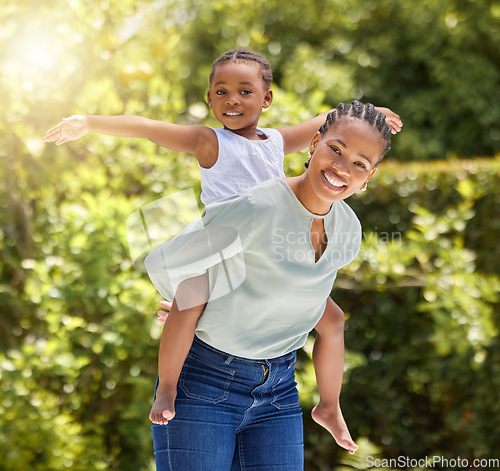 Image of Black family, portrait and piggy back outdoor with happiness and smile in a park. Mom, young girl and happy kid in nature with mother and child together on a lawn on summer holiday having fun