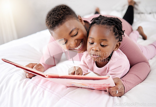 Image of Book, reading and mother with child in bed for learning, bond and fantasy at home. Storytelling, family and parent with girl in a bedroom with notebook for literature, relax and fun in their house