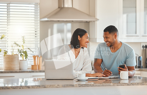 Image of Couple, kitchen and documents for budget, finance and smile with laptop, phone and writing notes in home. Man, woman and paperwork for savings, happy and computer for tax, compliance and investing