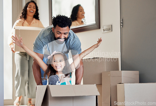 Image of Happy family, real estate and moving in new home playing with box for property, mortgage loan or celebration. Mother, father and little girl enjoying play time with boxes for fun bonding in the house