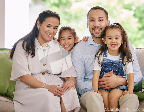 Image of Happy, smile and family portrait on a sofa with love, embrace and bonding in their home together. Face, children and parents on a couch relax, sweet or embracing in living room, cheerful and chilling
