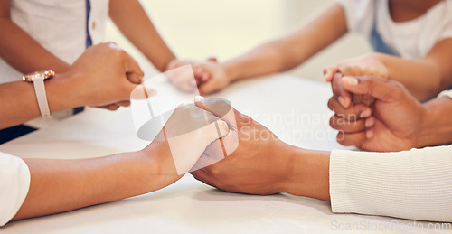 Image of Parents, children and holding hands for praying in a closeup with unity, support and connection at home. Gratitude, family and grace hand on a table in the house for faith, worship and peace.