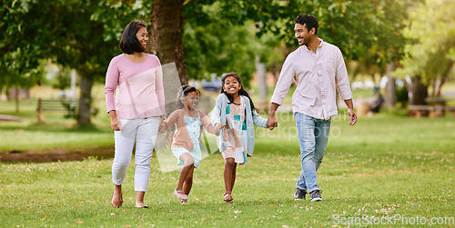 Image of Park, walk and happy family holding hands, talking and bonding with love, smile and fun in nature. Children, parents and walking in a forest together on the weekend, cheerful and enjoying holiday