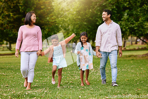 Image of Park, walk and happy family holding hands, talking and bonding with love, smile and fun in nature. Children, parents and walking in a forest together on the weekend, cheerful and enjoying holiday