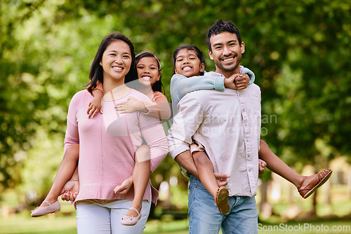 Image of Piggyback, portrait and asian family in a park happy, smile and having fun while bonding outdoor. Love, hug and face of parents carrying children in a forest, cheerful and playing games in nature