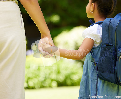 Image of Backpack, holding hands and child with mother, school and walking together outdoor. Hold hand, mom and student walk, travel and bonding at kindergarten with care, safety or security, support or trust