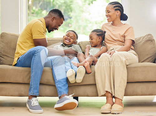 Image of Tickling, laughing and black family with children on home sofa for happiness, love and care. African kids, man and a woman or parents together on couch for fun, quality time and bonding while playing