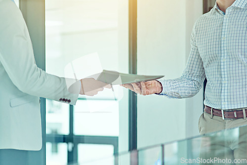 Image of Doing a handover. Shot of a businessman handing a document to a colleague.