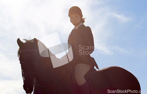 Image of Equestrian, lens flare and portrait of woman on horse for competition, training and show. Performance, riding and fitness with female jockey on stallion for animal, athlete and contest event