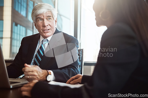 Image of Exchanging business information. Cropped shot of two businesspeople working together in the boardroom.