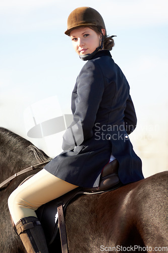 Image of Equestrian, sports and portrait of woman on horse for competition, training and show. Performance, riding and fitness with female jockey on stallion for animal, athlete and contest event