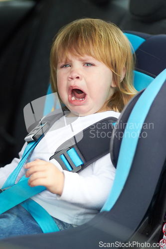 Image of Sad, crying and portrait of baby in car seat for fear, uncomfortable and travel safety. Security, transportation and journey with upset toddler for vacation trip, frustrated and protection