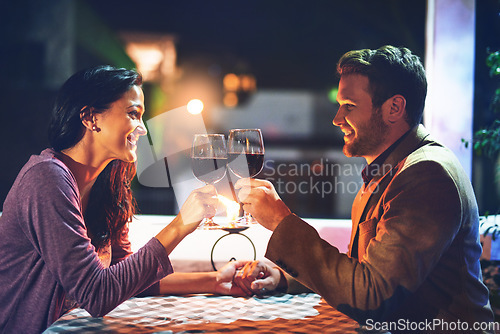 Image of Cheers, wine and couple on date in restaurant, romance and happiness in celebration of love and drinks. Romantic honeymoon night, man and woman toast glasses in cafe, smile on dinner holiday travel.