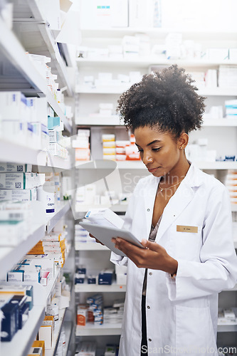 Image of I have the right tools to keep my pharmacy under control. Cropped shot of a pharmacist using a digital tablet in a chemist.