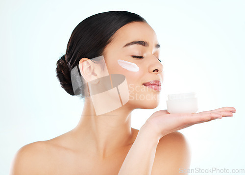 Image of Skincare, face cream and woman with container in studio isolated on a white background. Lotion, dermatology product and female model with sunscreen, beauty cosmetics or smell healthy skin moisturizer