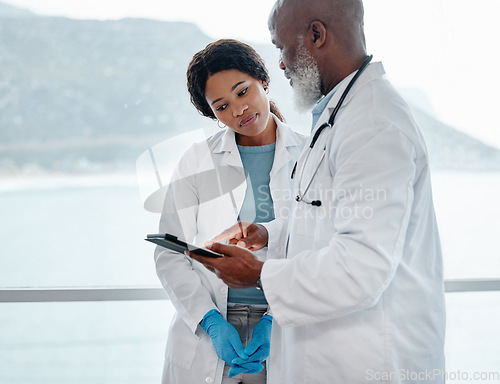Image of African doctors, teamwork and talking with tablet, data analysis or results for healthcare in hospital. Senior black man, woman and medical discussion with digital touchscreen for wellness in clinic