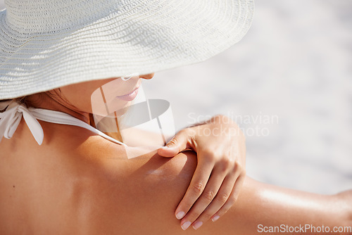 Image of Sunscreen, shoulder and a woman on the beach in summer for travel, vacation or holiday on the coast. Wellness, skincare and protection with a female tourist outdoor to apply lotion to her soft skin
