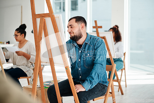 Image of Art is a form of expression. Cropped shot of a diverse group of artists sitting together and painting during an art class in a studio.